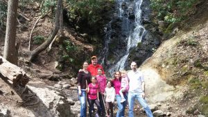 Group photo on the hike trail with water falls