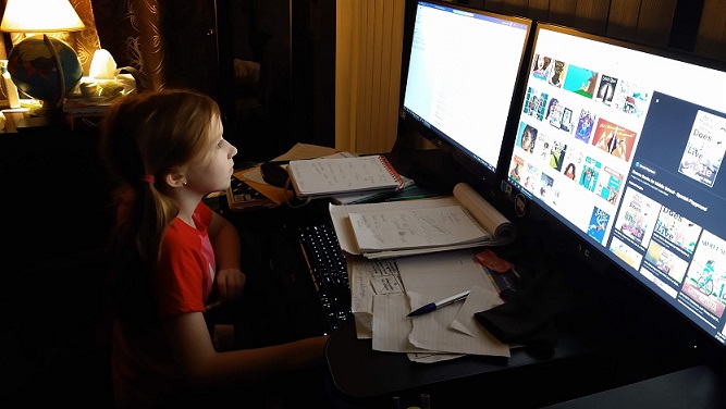 My daughter edits my work on the computer.